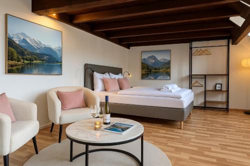 a bedroom with a bed and a table and chairs at STAYS Bodensee Apartments in Stetten