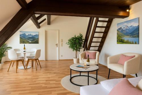 a living room with a table and chairs at STAYS Bodensee Apartments in Stetten