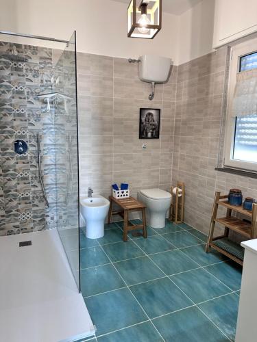 a bathroom with a shower and a toilet and a sink at La casetta bellevue suite in Torre del Greco