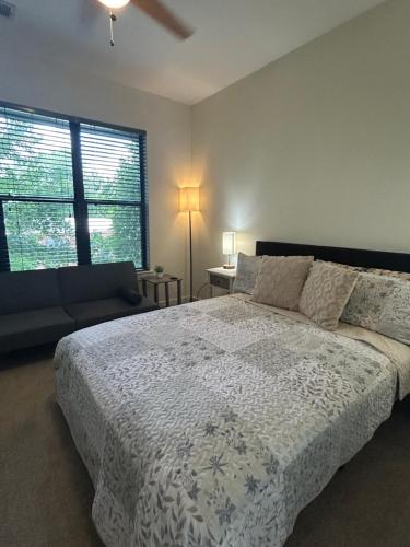 a bedroom with a large bed and a window at 2 Bedroom Boutique Apartment in the Heart of Charlotte in Charlotte