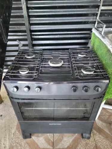 a stove top oven sitting on the ground at Beach house minutes from Ochi Rios and Ian Fleming airport in Salt Gut Pen