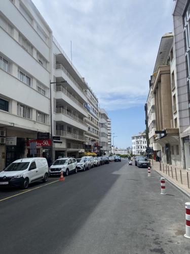 a street with cars parked on the side of a building at Rabat Easy Access in Rabat