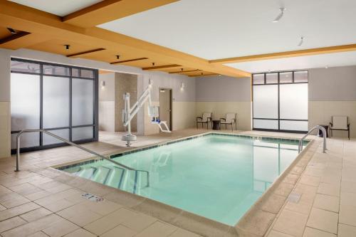 a swimming pool with blue water in a building at Courtyard by Marriott Portland Downtown/Waterfront in Portland