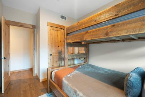 a bedroom with two bunk beds and a closet at Timberstone Condo by Canadian Rockies Vacation Rentals in Canmore