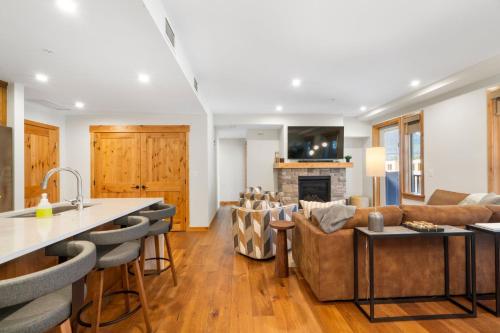 a kitchen and living room with a couch and a table at Timberstone Condo by Canadian Rockies Vacation Rentals in Canmore