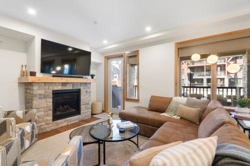 a living room with a couch and a fireplace at Timberstone Condo by Canadian Rockies Vacation Rentals in Canmore