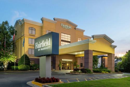 a hotel building with a sign in front of it at Fairfield Inn and Suites Atlanta Airport South/Sullivan Road in Atlanta