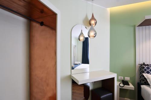 a room with a white desk and a mirror at The MONT BOUTIQUE HOTEL in Shkodër