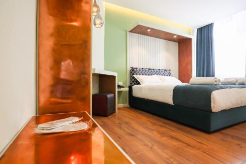 a hotel room with a bed and a table at The MONT BOUTIQUE HOTEL in Shkodër