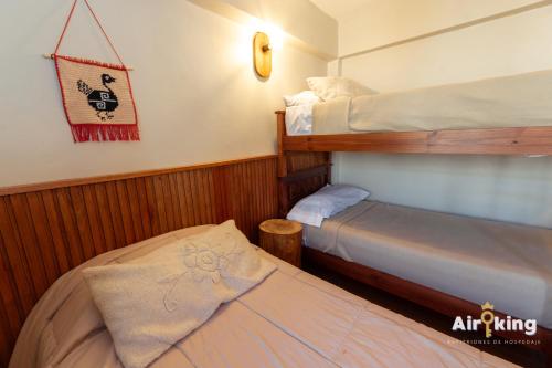 a small bedroom with two bunk beds in it at Hotel FG Tafi in Tafí del Valle