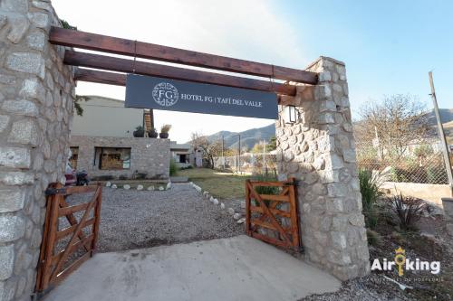 a entrance to a building with a wooden gate at Hotel FG Tafi in Tafí del Valle