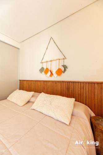 a bed with two pillows in a bedroom at Hotel FG Tafi in Tafí del Valle