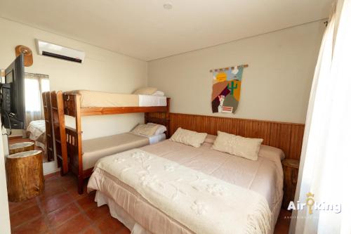 a bedroom with a bed and a bunk bed at Hotel FG Tafi in Tafí del Valle