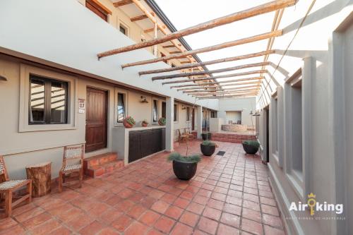 an indoor patio with potted plants and awnings at Hotel FG Tafi in Tafí del Valle