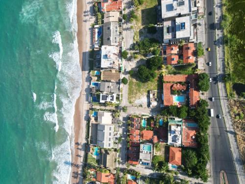 an aerial view of a beach with houses and the ocean at Pousada Flor de Merepe - Porto de Galinhas in Porto De Galinhas