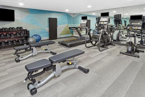 a gym with a bunch of exercise bikes and weights at Candlewood Suites Appleton by IHG in Appleton