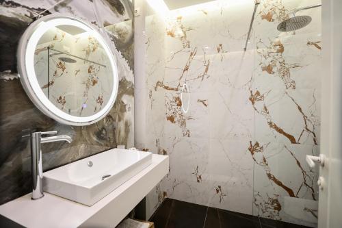 a bathroom with a sink and a mirror at The MONT BOUTIQUE HOTEL in Shkodër