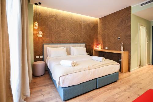 a bedroom with a bed with two towels on it at The MONT BOUTIQUE HOTEL in Shkodër