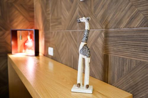 a wooden toy giraffe sitting on a table at The MONT BOUTIQUE HOTEL in Shkodër