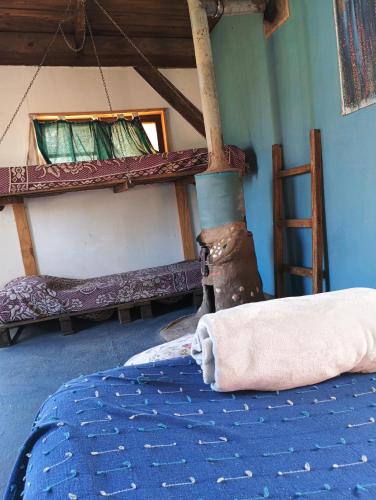 a room with a bed with a towel on it at Mama Killa Neptunia Eco hostel in Salinas 