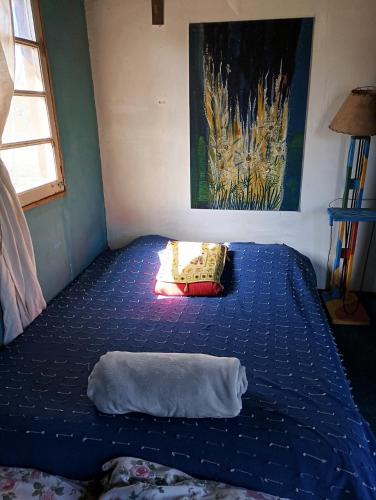 a bed in a room with a pillow on the floor at Mama Killa Neptunia Eco hostel in Salinas 