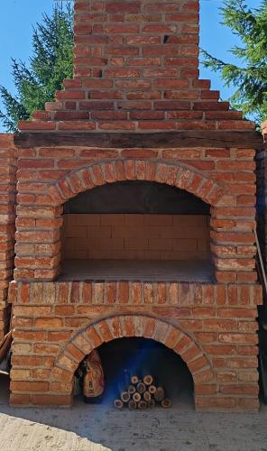 a brick oven with a pile of fire wood at CaSa ViTo Kumrovec 