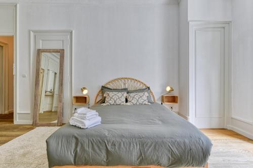 a bedroom with a large bed and a mirror at Majestic Chamonix in Chamonix-Mont-Blanc