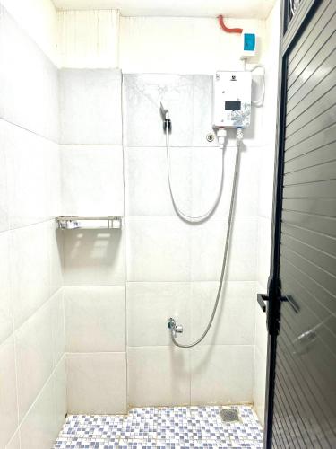 a shower with a hose in a bathroom at Vegas Resort and Hotel in Balayong