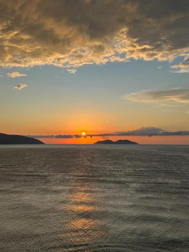 a sunset over a body of water at Hotel Sanremo Vlore in Vlorë