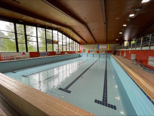 an empty swimming pool in a large building at Baita Snow Valtellina in Chiesa in Valmalenco