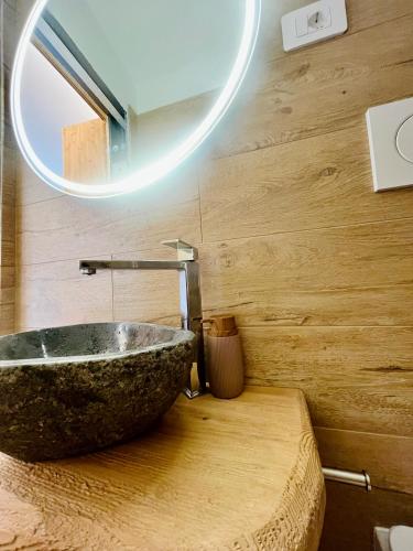 a bathroom with a large stone tub on a table at Baita Snow Valtellina in Chiesa in Valmalenco