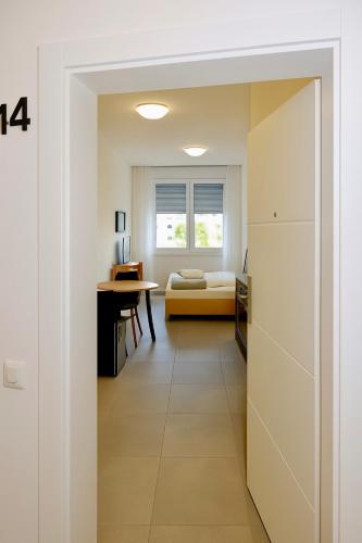 a room with a bed and a desk and a window at Ok Apartments in Pforzheim