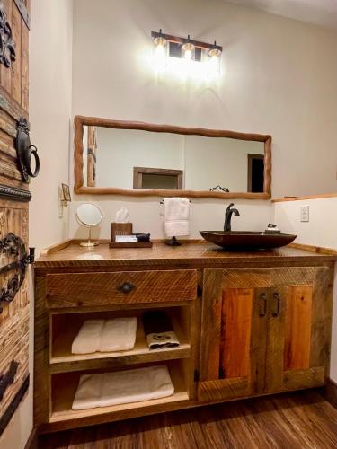 a bathroom with a sink and a mirror at The Dogwood Inn in Blue Ridge