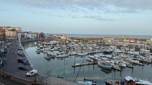 a bunch of boats are docked in a harbor at Reverie Escape by Halisi in Ramsgate