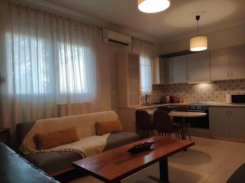 a living room with a couch and a table at 3 STEPS in Alexandroupoli