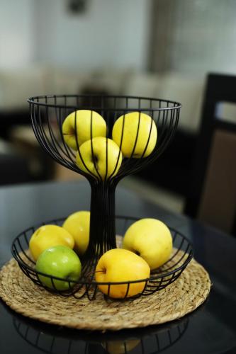 a bowl of bananas and lemons on a table at ILIEVSKI apartment 4 in Kumanovo