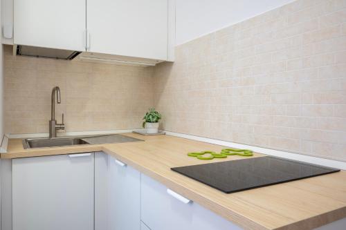 a kitchen with a counter with a sink and some scissors at Briks in Caselle Torinese