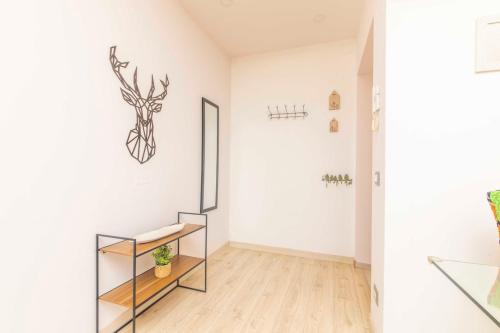 a white room with a shelf and a deer head on the wall at Willow's House Assisi Big house for Family and friends in Tordibetto