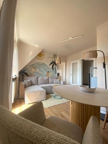 a living room with a couch and a table at Küstenbutze Büsum in Büsum