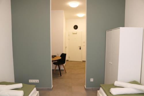 a room with two beds and a table at Ok Apartments in Pforzheim