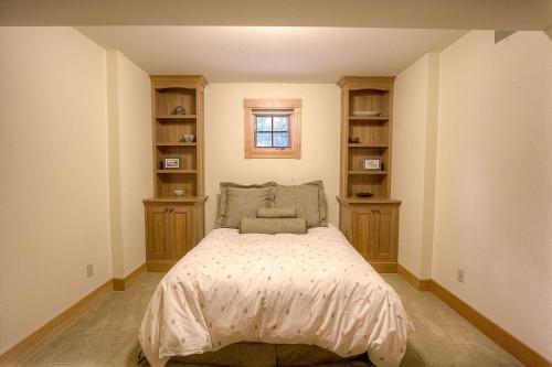 a bedroom with a bed with a window and shelves at COH1444 - Fallen Leaf Relief home in Fallen Leaf