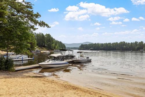 two boats are docked at a dock on a lake at Lake Escape Family & Pet Friendly with Dock Access in Freedom