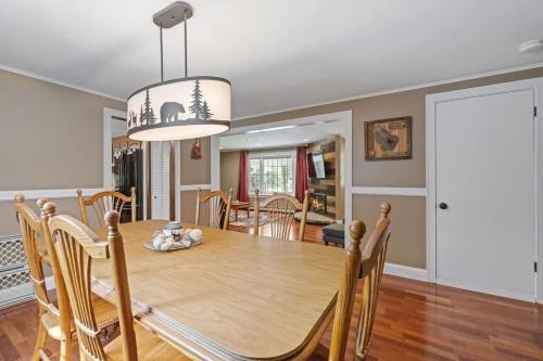 a dining room and living room with a table and chairs at Lake Escape Family & Pet Friendly with Dock Access in Freedom
