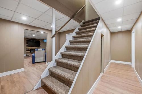 a staircase in an office building with a stair case at Lake Escape Family & Pet Friendly with Dock Access in Freedom