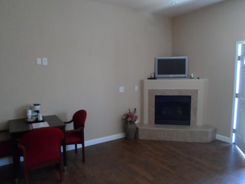 a living room with a fireplace with a tv on top at 2172 main st in Morro Bay