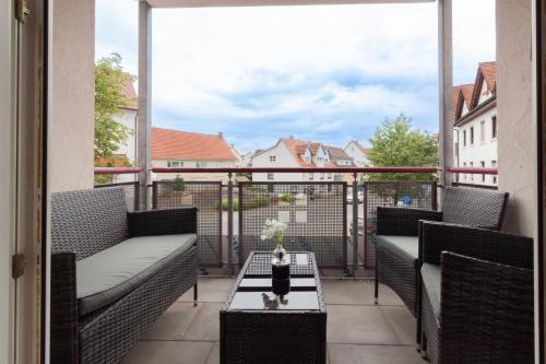 a balcony with chairs and a table with a view at nJoy! Federsee Getaway - Central - Coffee - Balcony - perfect for business and travel in Bad Buchau