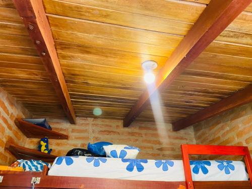 a room with a wooden ceiling with a bed in it at CAMVUL Farm Lodge - Finca Hotel in Palmito Palma