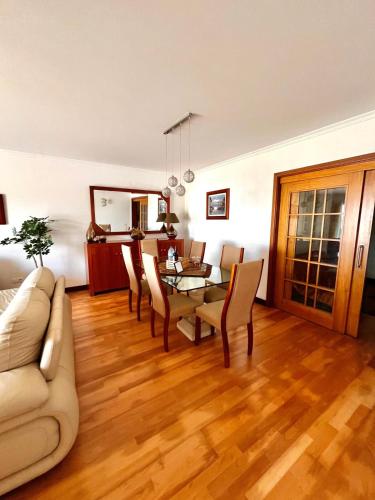 a living room with a table and chairs and a couch at Apartment Vista Marina in Torreira
