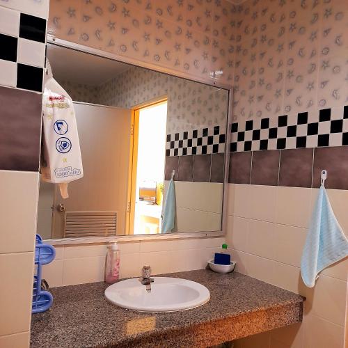 a bathroom with a sink and a mirror at Sport Villa Condo in Hua Hin