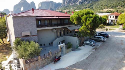 a house with cars parked in front of it at Polyzos Luxury Suites Meteora #5 - Adults Friendly in Kalabaka